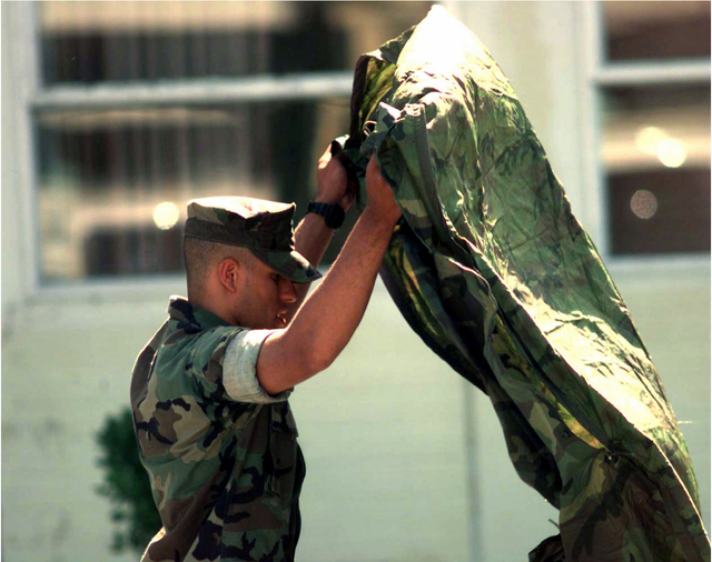 Soldier lifting woobie poncho liner